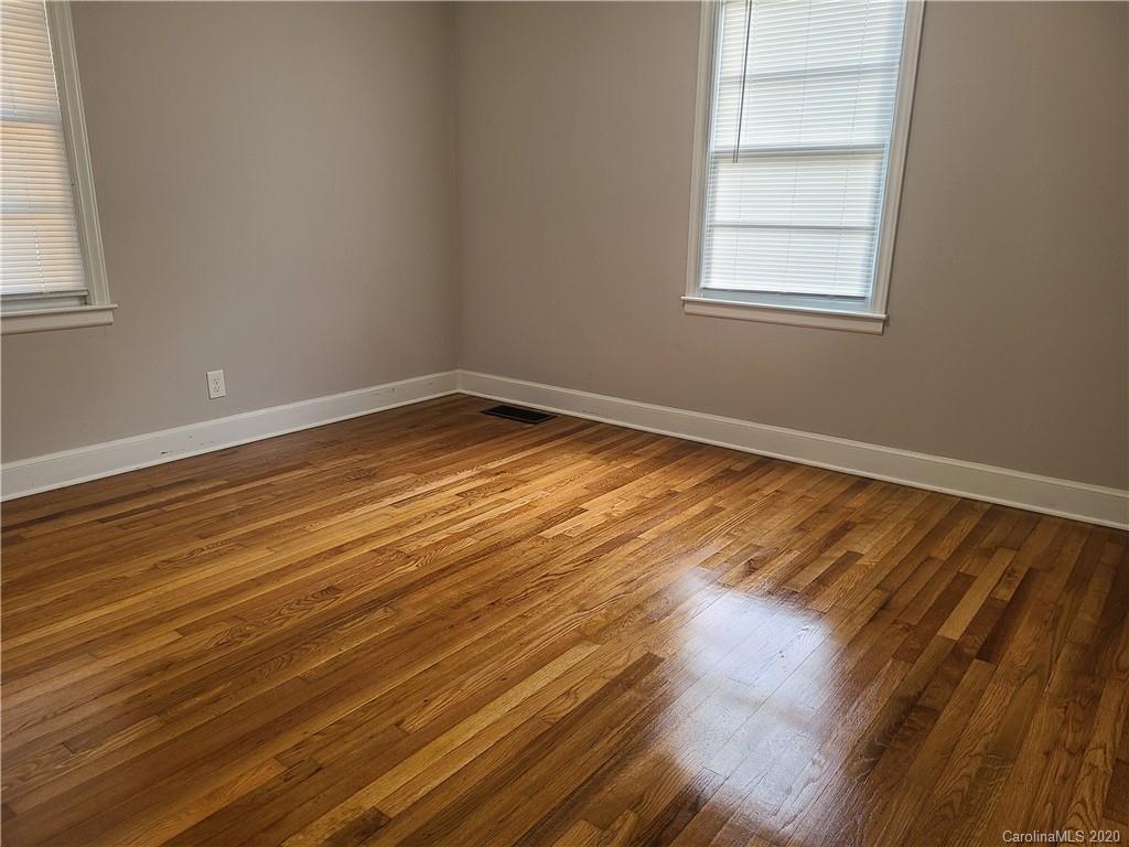 1820 Linwood Road Gastonia, NC 28052 - Photo 18 of 24 an empty room with wooden floor and windows