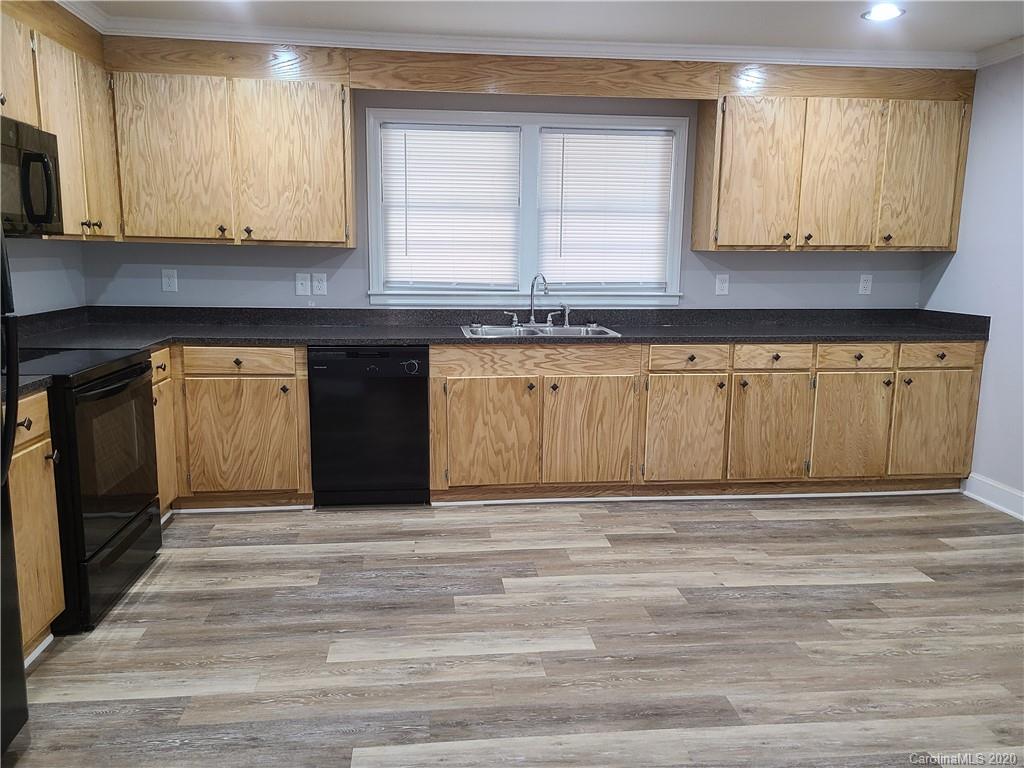 1820 Linwood Road Gastonia, NC 28052 - Photo 6 of 24 a view of a kitchen with granite countertop cabinets and a wooden floor