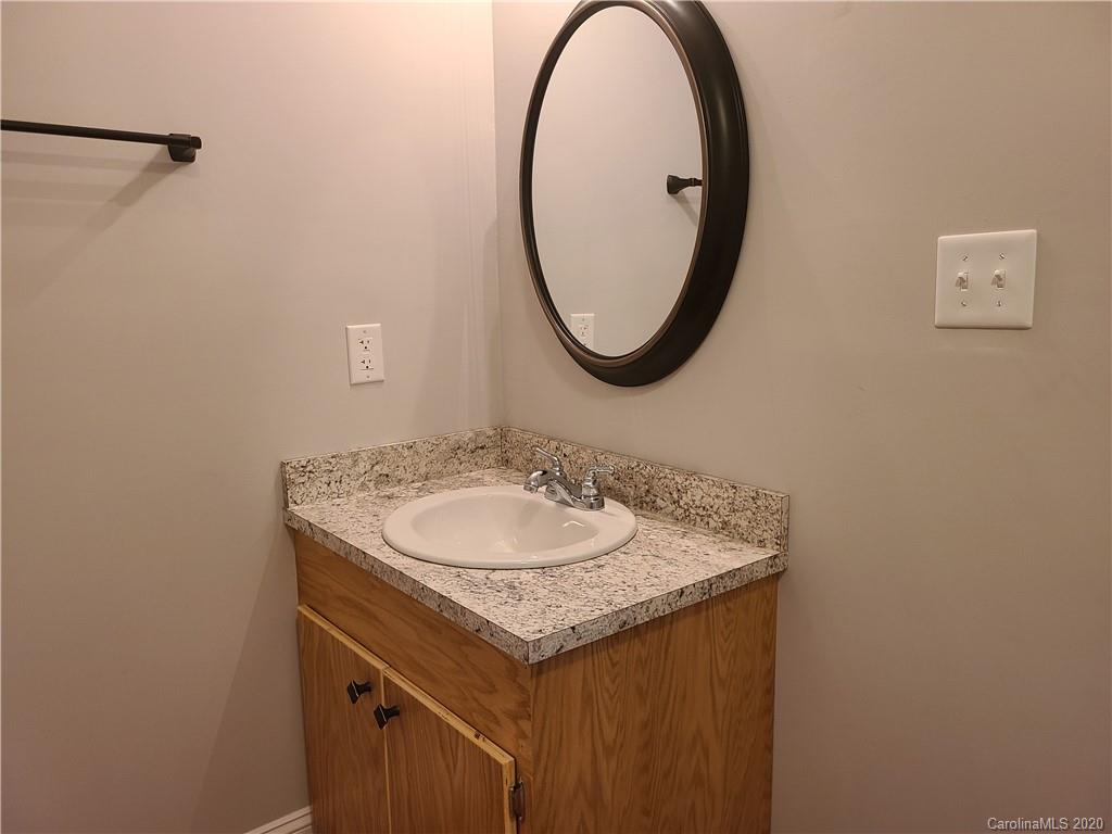 1820 Linwood Road Gastonia, NC 28052 - Photo 9 of 24 a bathroom with a sink and a mirror