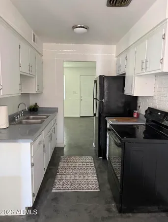a kitchen with a sink stove and refrigerator