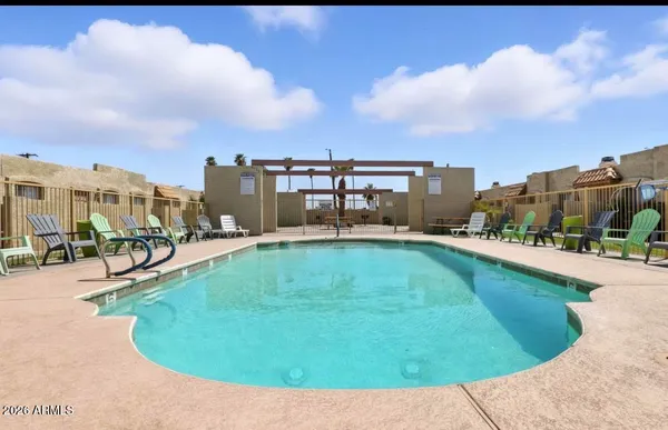 a swimming pool with outdoor seating and yard