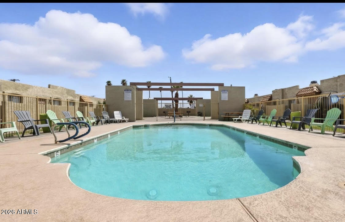 4337 West Keim Drive, Unit 4 Glendale, AZ 85301 - Photo 3 of 7 a swimming pool with outdoor seating and yard