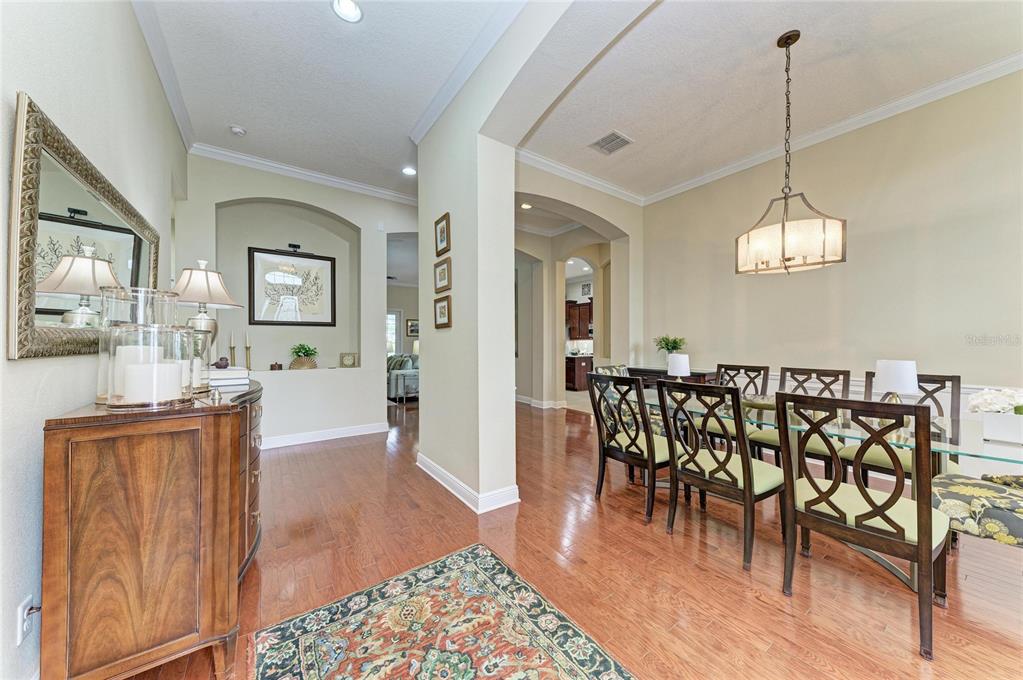 302 Cockle Shell Loop Apollo Beach, FL 33572 - Photo 6 of 75 a view of a dining room with furniture window and wooden floor