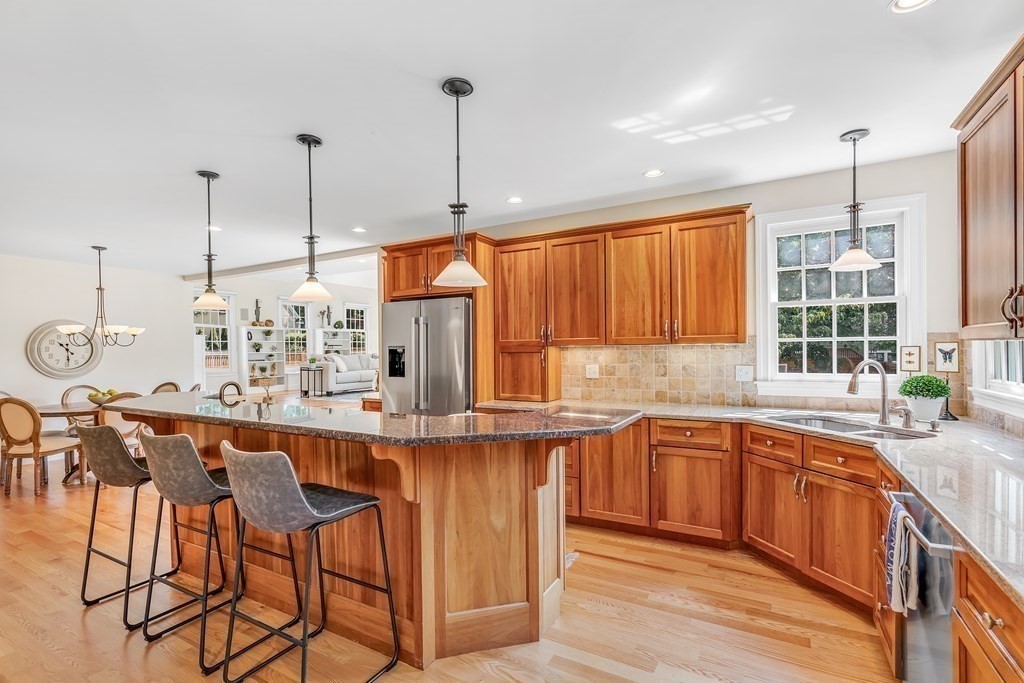 96 Pilgrim Road Concord, MA 01742 - Photo 5 of 24 a kitchen with stainless steel appliances granite countertop a sink a stove and a wooden floors