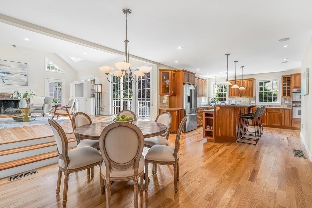 96 Pilgrim Road Concord, MA 01742 - Photo 6 of 24 a dining room with furniture a chandelier and wooden floor