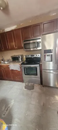 a kitchen with kitchen island a stove and a sink