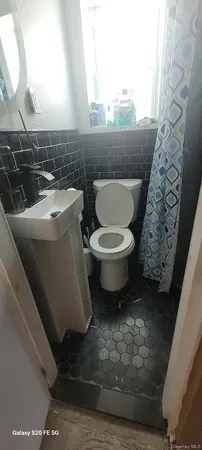 a bathroom with a toilet and a sink