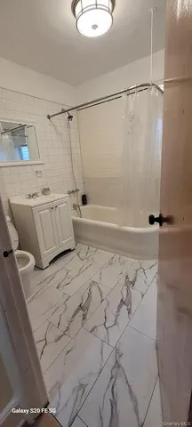 a bathroom with a shower and a bathtub