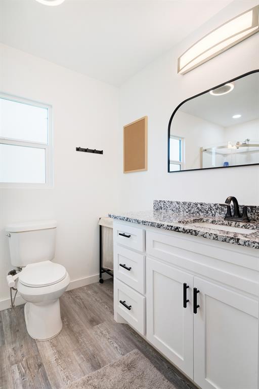 600 Private Road Brookston, TX 75421 - Photo 15 of 26 a bathroom with a granite countertop toilet sink and mirror