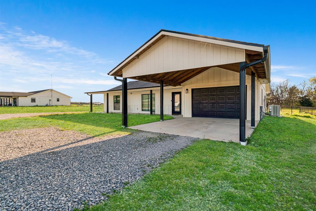600 Private Road Brookston, TX 75421 - Photo 18 of 26 a front view of a house with a yard and garage