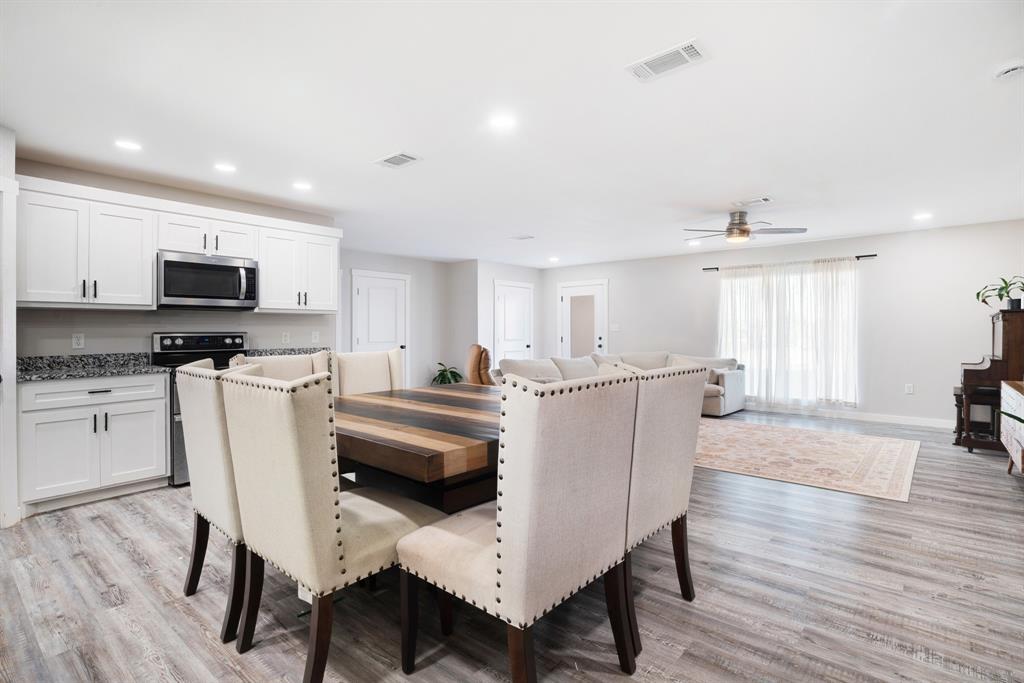 600 Private Road Brookston, TX 75421 - Photo 9 of 26 a living room with furniture a flat screen tv and kitchen view