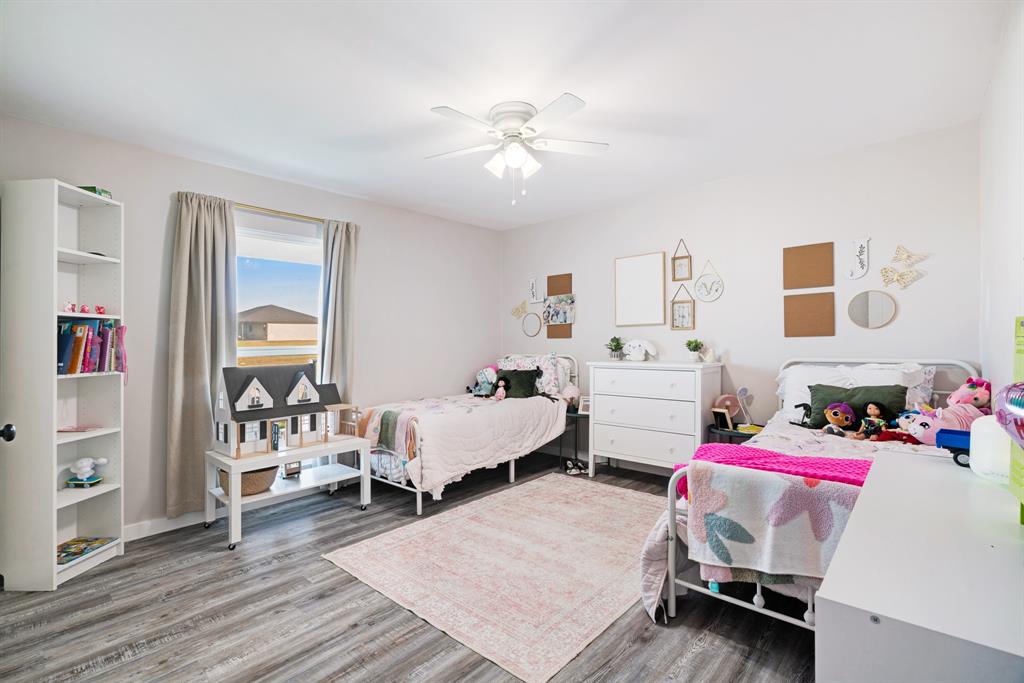 600 Private Road Brookston, TX 75421 - Photo 10 of 26 a bedroom with furniture and a wooden floor