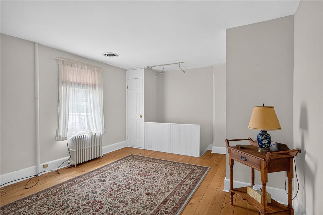 765 East Macada Road Bethlehem, PA 18017 - Photo 32 of 46 Hardwood flooring extends throughout this versatile living space, offering warmth and natural character.
