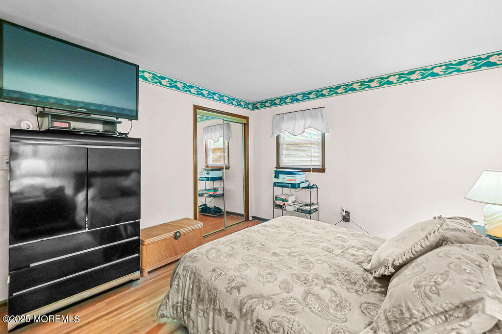 308 Stone Road Hazlet, NJ 07730 - Photo 11 of 58 a bedroom with a bed and a flat tv screen on dresser