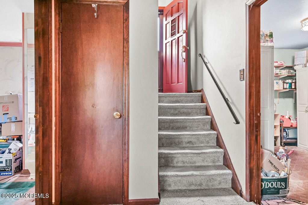 308 Stone Road Hazlet, NJ 07730 - Photo 12 of 58 a view of staircase with white walls and railing