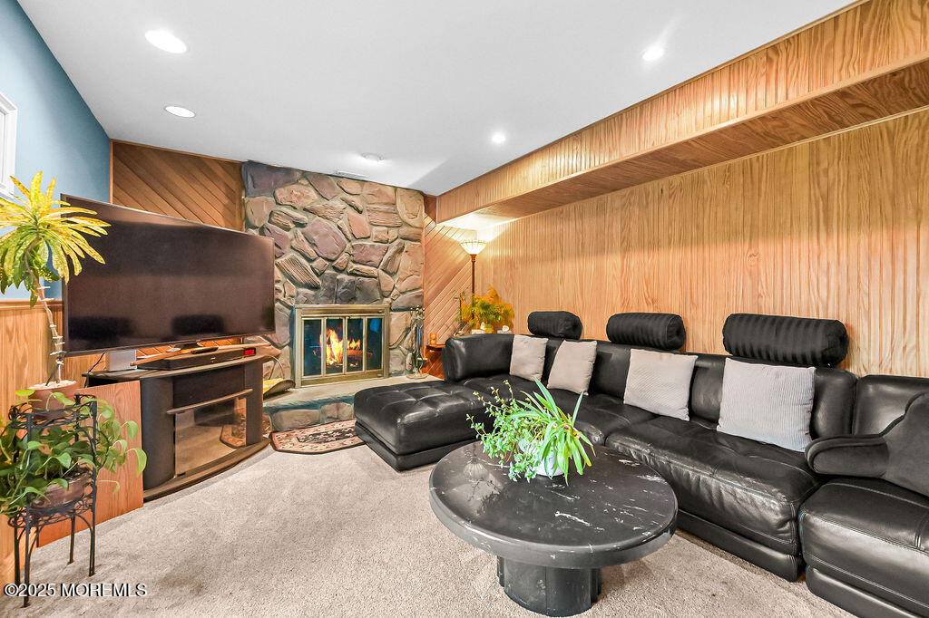308 Stone Road Hazlet, NJ 07730 - Photo 16 of 58 a living room with furniture a chandelier and a fireplace