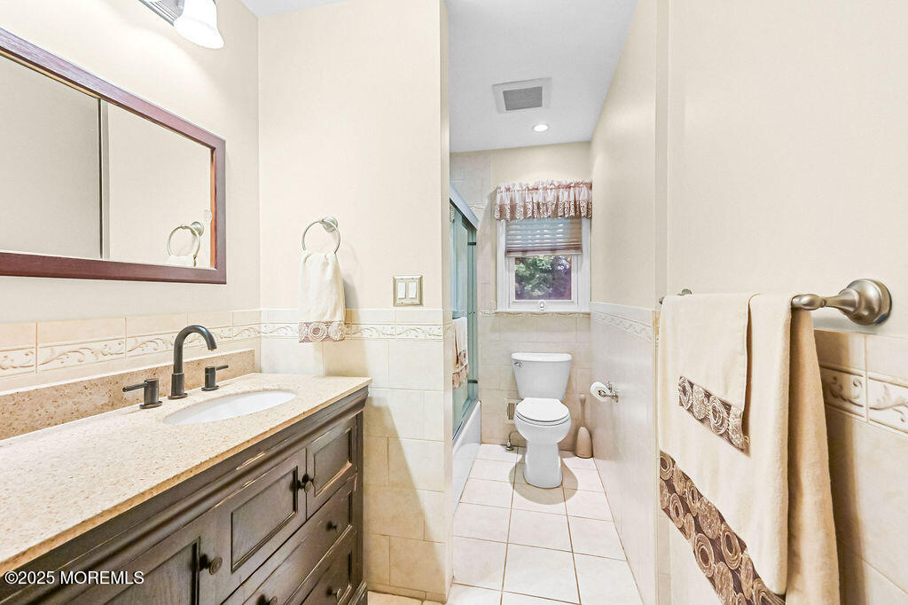 308 Stone Road Hazlet, NJ 07730 - Photo 17 of 58 a bathroom with a sink a toilet and a mirror