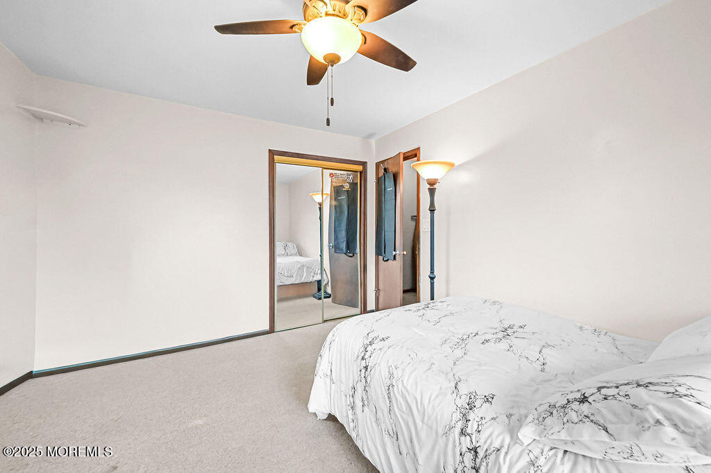 308 Stone Road Hazlet, NJ 07730 - Photo 18 of 58 a bedroom with a bed and a chandelier