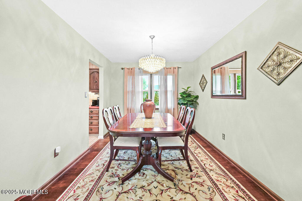 308 Stone Road Hazlet, NJ 07730 - Photo 3 of 58 a dining room with furniture a rug and a chandelier