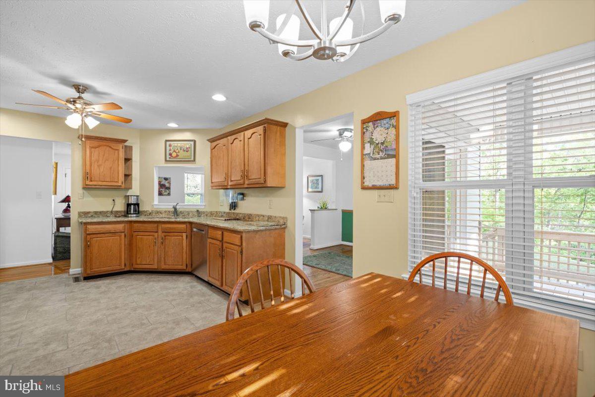 116 Ware Place Winchester, VA 22602 - Photo 11 of 28 a kitchen with a refrigerator a sink dishwasher a dining table and chairs with wooden floor
