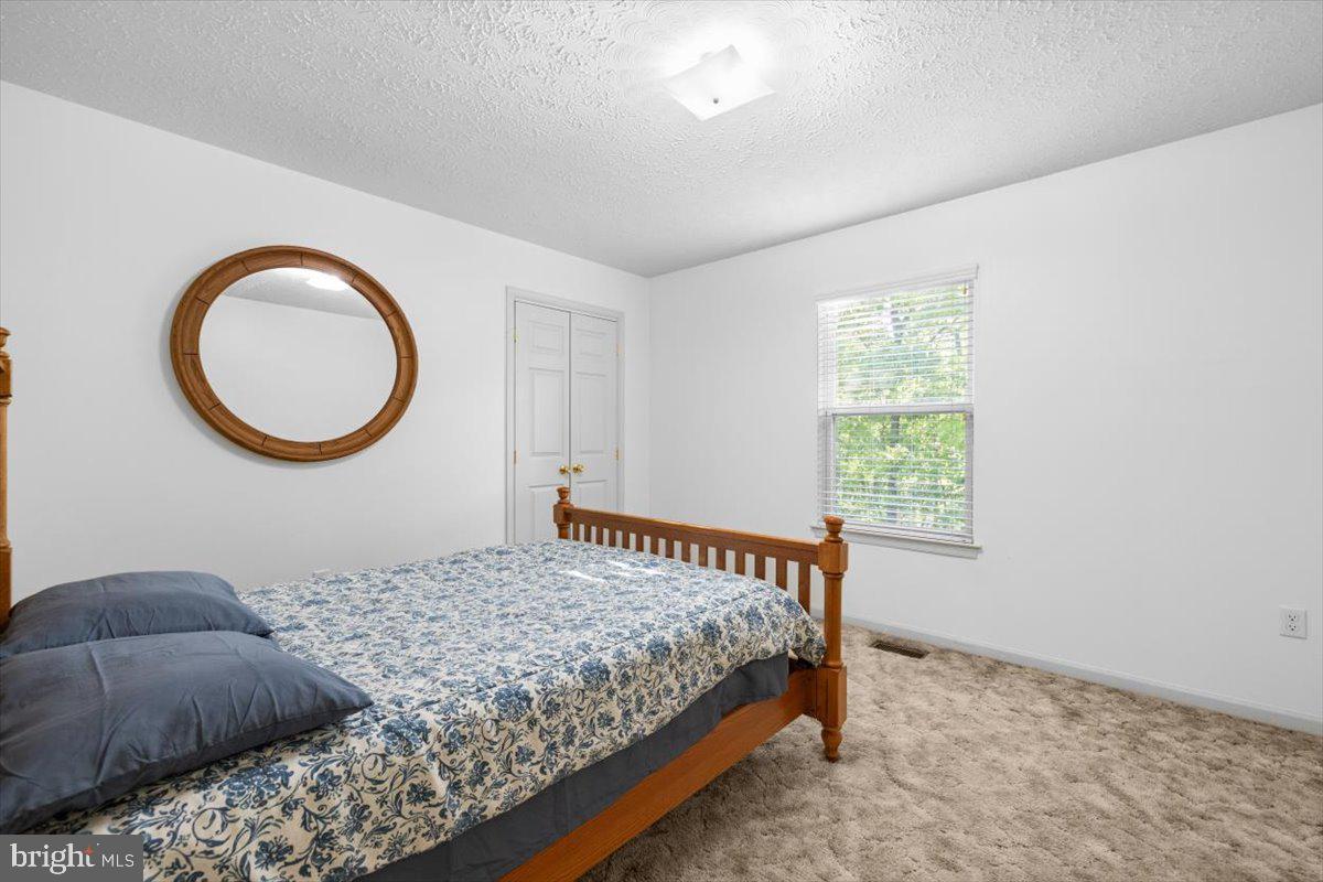 116 Ware Place Winchester, VA 22602 - Photo 14 of 28 a bedroom with a bed and a window
