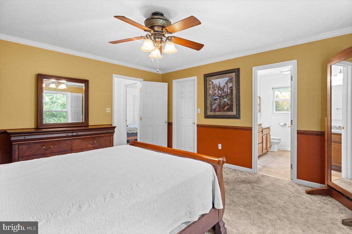 116 Ware Place Winchester, VA 22602 - Photo 16 of 28 a bedroom with a large bed and a chandelier
