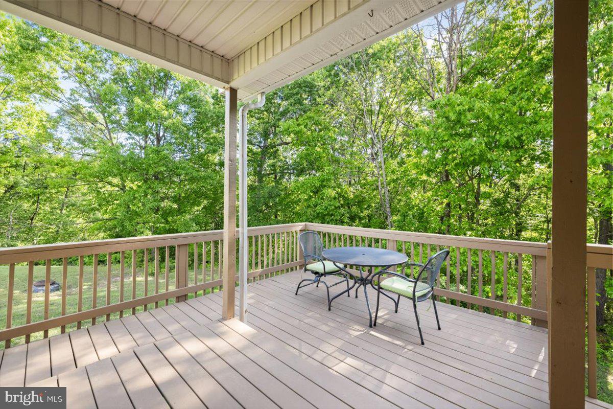 116 Ware Place Winchester, VA 22602 - Photo 21 of 28 a balcony with wooden floor table and chairs
