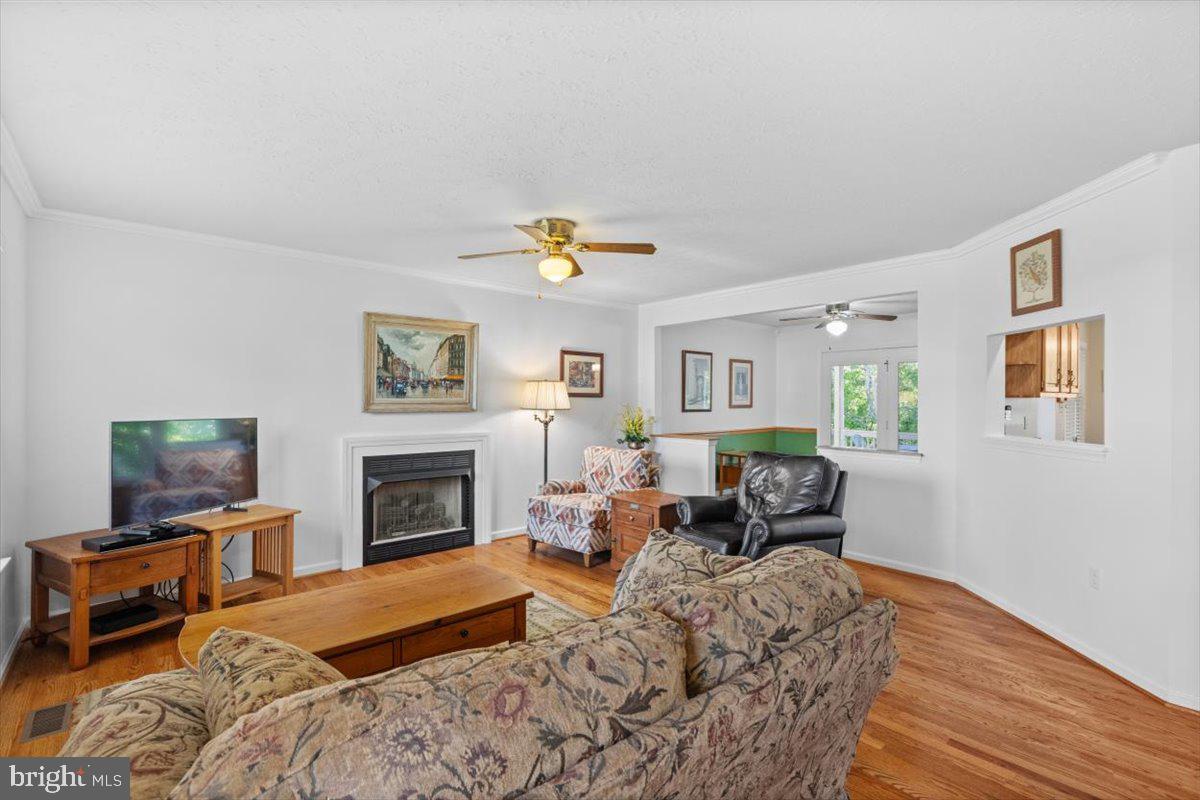 116 Ware Place Winchester, VA 22602 - Photo 4 of 28 a living room with furniture a fireplace and a flat screen tv