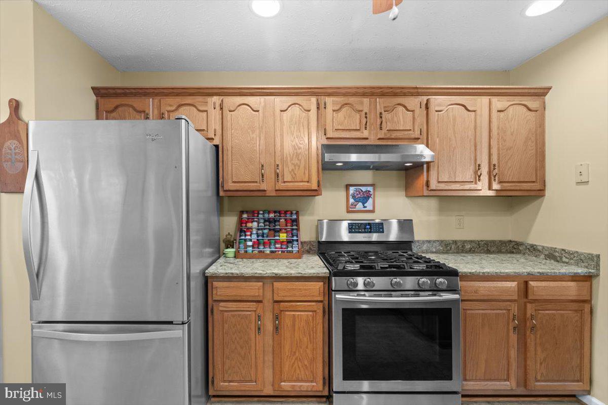 116 Ware Place Winchester, VA 22602 - Photo 9 of 28 a kitchen with stainless steel appliances granite countertop a refrigerator stove and cabinets