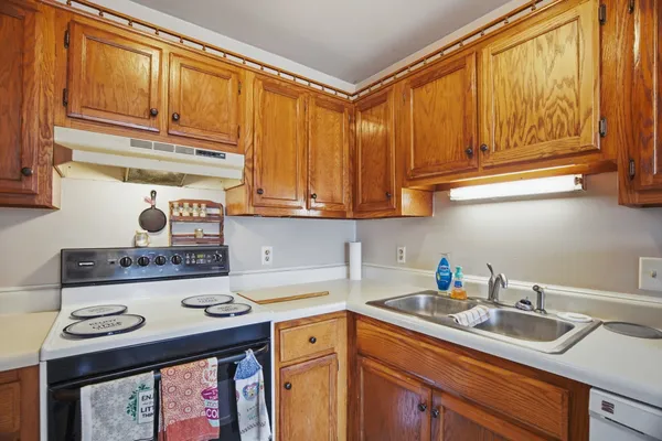 a kitchen with stainless steel appliances granite countertop a sink stove and cabinets