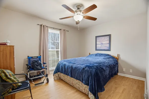 a bedroom with a bed and a window