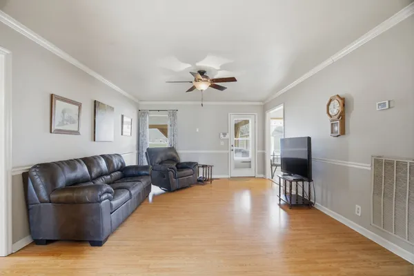a living room with furniture and a flat screen tv