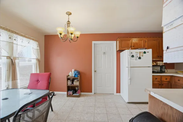 a view of kitchen with furniture and refrigerator