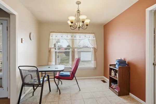 a dining room with furniture and window