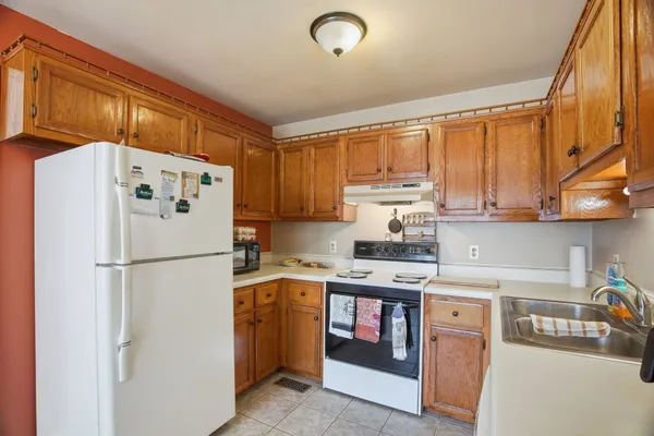 a white refrigerator freezer sitting in a kitchen