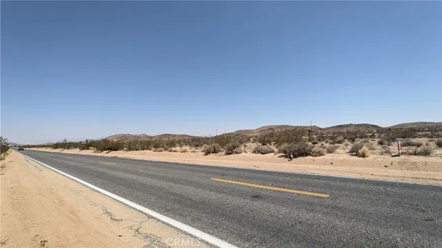 a view of an ocean beach and mountain