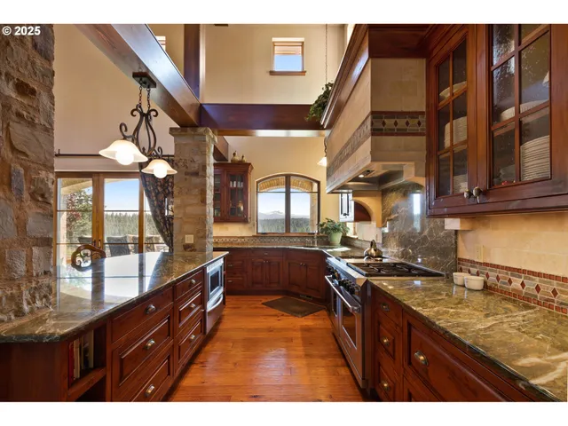 a kitchen with stainless steel appliances granite countertop a sink and stove