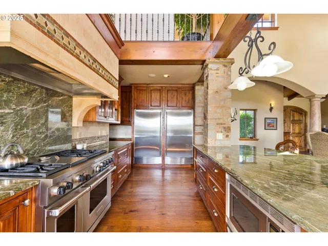 a kitchen with stainless steel appliances granite countertop a stove and cabinets