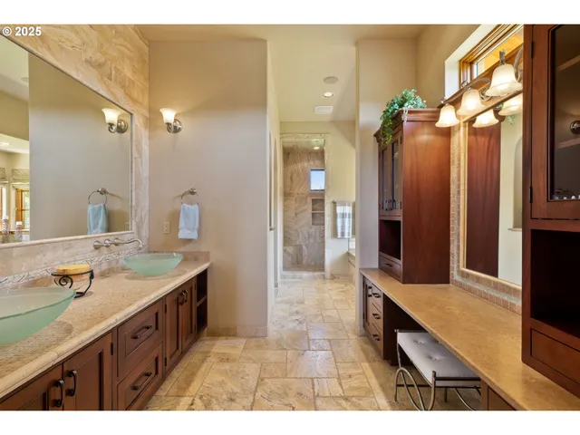 a bathroom with a sink a mirror and a shower