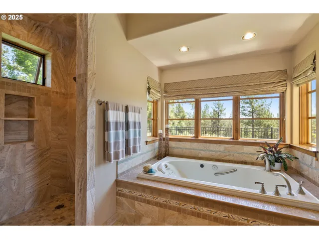 a view of walk in closet with clothes