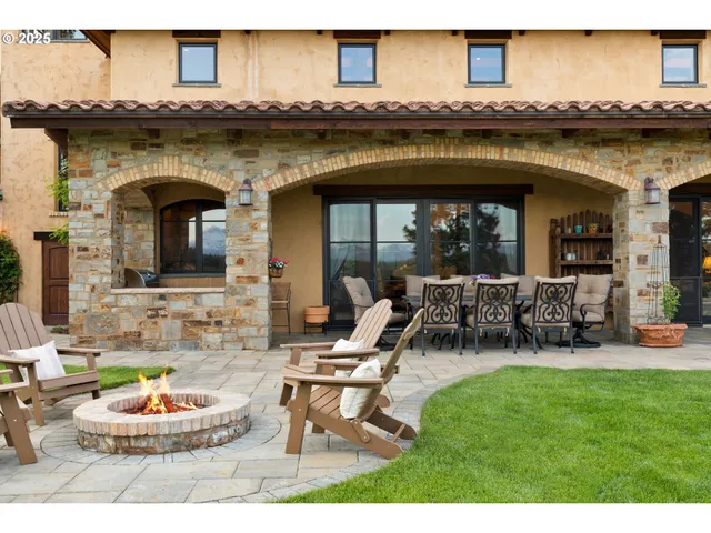 a view of a lake with a table and chairs in the garden