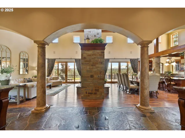 a view of hall way with furniture and hardwood floor