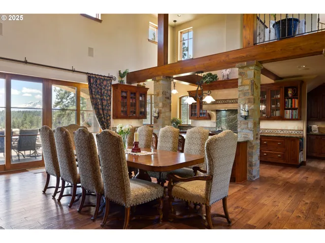 a dining room with furniture a chandelier and wooden floor