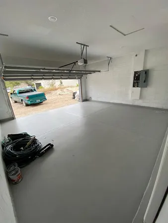 a room with water heater and a wooden floor