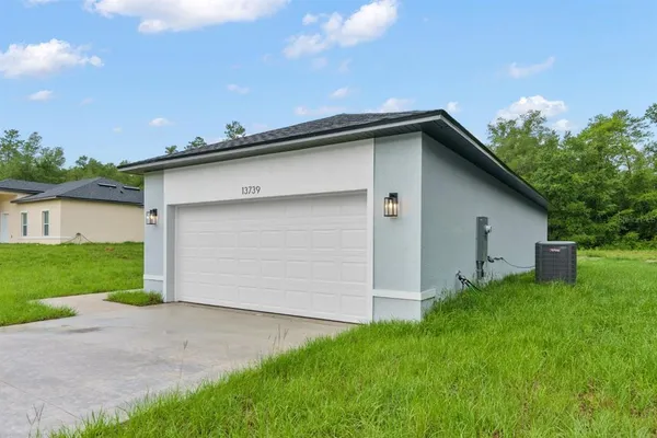 a view of backyard of house with garage and yard