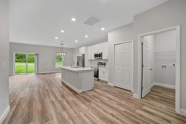 a view of kitchen with sink and refrigerator