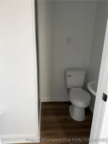 a toilet sitting in a bathroom next to a white wall