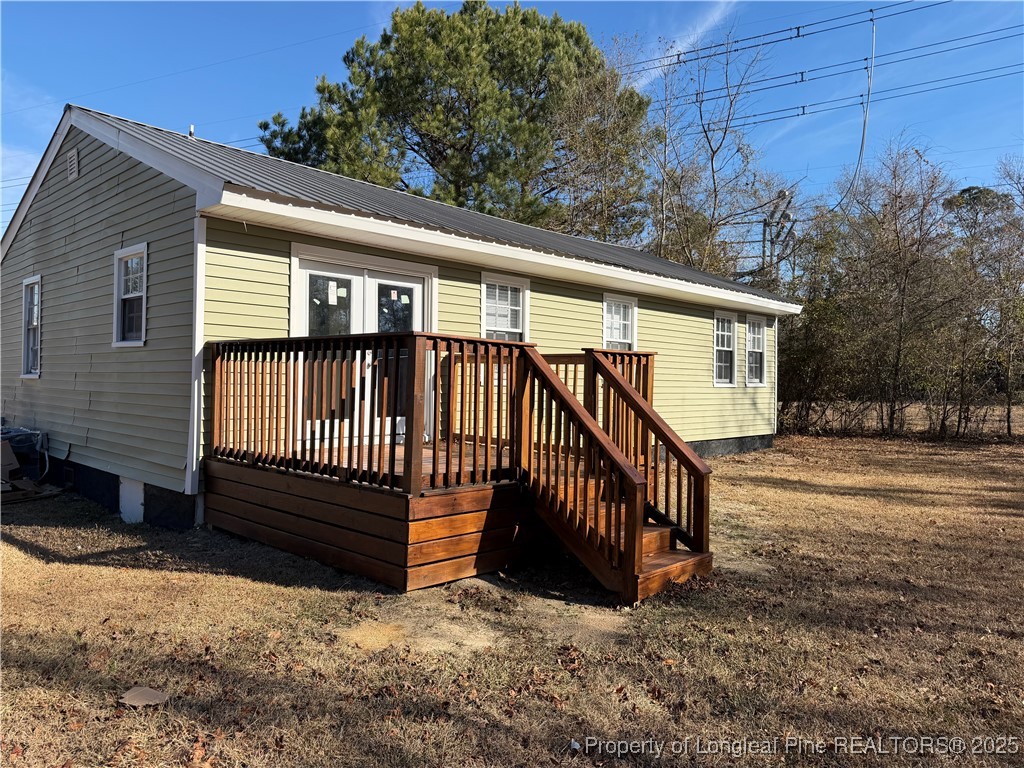 415 Vass Road Spring Lake, NC 28390 - Photo 2 of 12 a view of a house with a yard next to a road