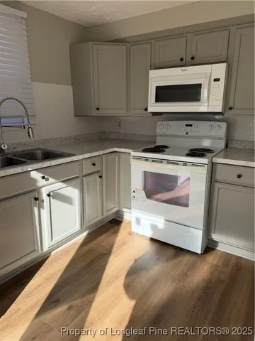 a kitchen with a stove and a microwave