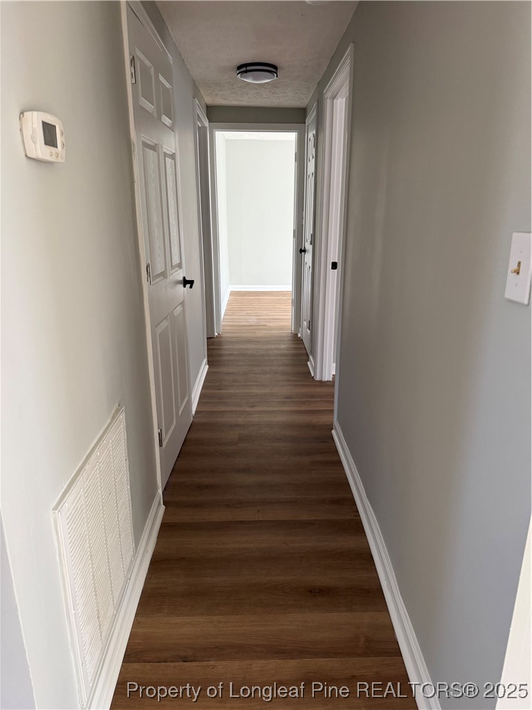 415 Vass Road Spring Lake, NC 28390 - Photo 7 of 12 a view of a hallway with wooden floor and staircase